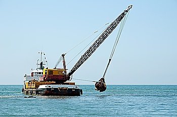 Barge dredging a harbor