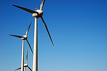 Eolic power generator: windmills over blue sky 