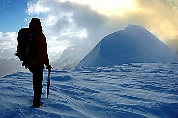 A lonely climber reaching an high mountain pass