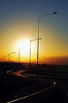 Highway overpass in backlight at sunset