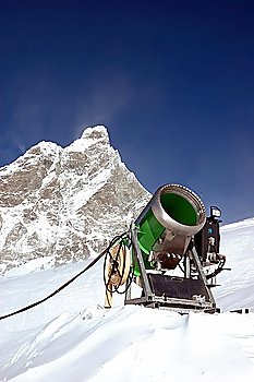 Snow-gun on a ski slope , mountain ski resort
