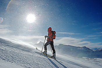 A lonely backcountry skier in snowstorm, horizontal orientation