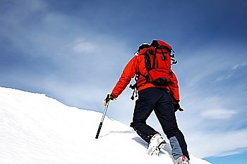 Climber on a snowy ridge; horizontal frame. Italian alps.
