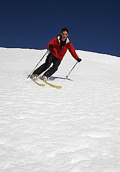 Young male freerider skier moving down
