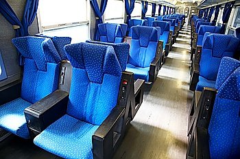 Vacant seats inside an empty passenger train. Horizontal frame.