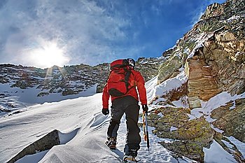 Mountaineer during a winter climb; horizontal frame. Italian alps.