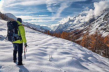 Exploration concept: a lonely hiker in the wilderness. Mont Blanc massif, Val Ferret, Courmayeur, Valle d´aosta, Italy.