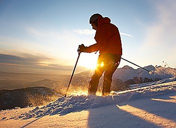 Freerider skier moving down in snow powder at sunset; italian alps.