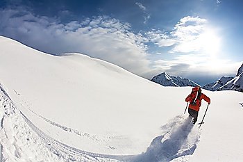 Freerider skier moving down in snow powder; italian alps.