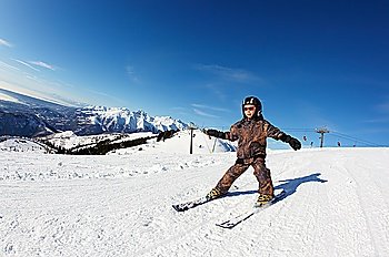 Child skiing on a slope against a clear sky. Bielmonte, Biella, Piemonte, Italy
