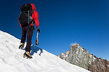 Climber on a snowy ridge, Grivola, west italian alps, Europe. Horizontal frame.