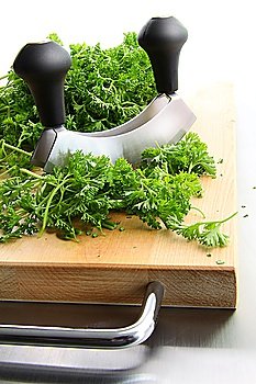 Freshly chopped parsley on wooden cutting