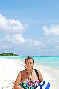 close up of a senior woman walking on a Maldivian Island
