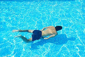 vibrant photo of a young adult swimming underwater
