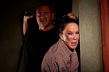 Frightened woman in hallway with menacing man