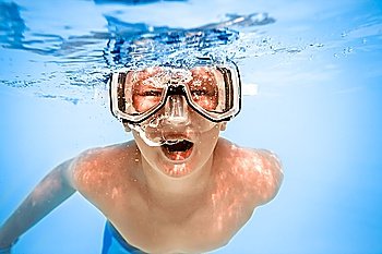 boy under water in pool