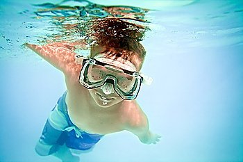 boy under water in pool