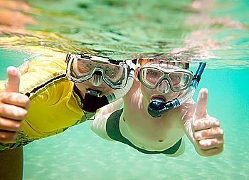 Two children under water in masks