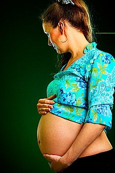 pregnant girl on a green background 