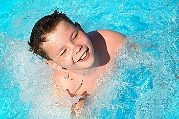 The joyful boy in pool