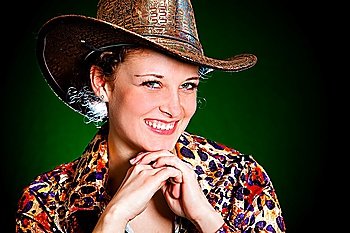 girl in a cowboy´s hat on a green background