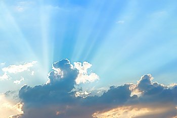 Beautiful blue sky with sunbeams and clouds