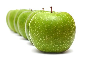 green apples in row isolated on white