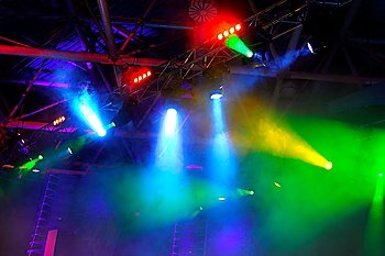 lighting equipment  at concert - colored spotlights on ceiling in smoke