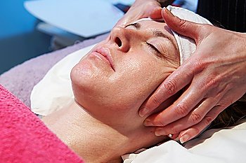 woman having a facial treatment in beauty salon