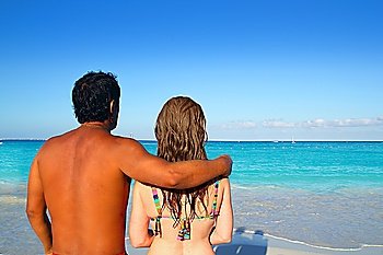 ethnic mixed couple man woman vacation tropical turquoise beach Caribbean