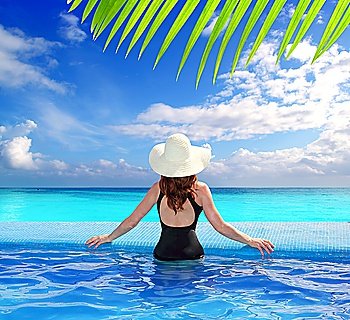 Caribbean tropical sea view from blue pool rear woman beach hat