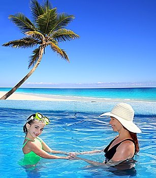 daughter and mother in swimming pool tropical location background