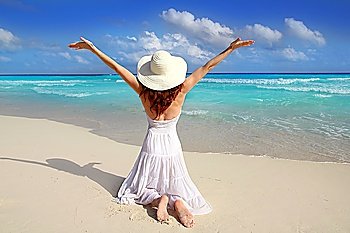 Caribbean beach woman rear on knees open arms happy vacation gesture