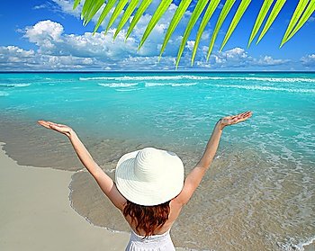 Caribbean beach woman rear view hat open arms happy vacation gesture
