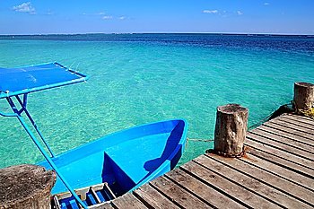 blue boat in wooden tropical pier in Caribbean beach
