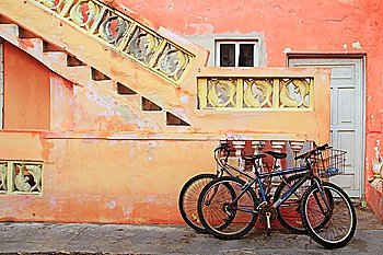 bicycles on grunge tropical Caribbean orange yellow facade Mexico