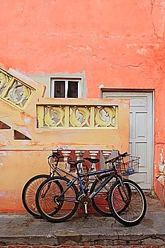 bicycles on grunge tropical Caribbean orange yellow facade Mexico