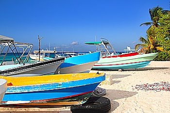 colorful tropical boats beached in the sand Isla Mujeres Mexico