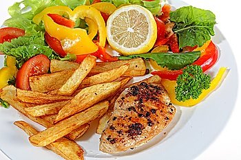 A meal of marinated pepper chicken breast served with french fries and a salad of lettuce, tomato, rocket, capsicum and a slice of lemon.