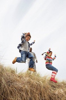 Father And Children Having Fun In Sand Dunes