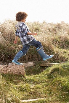 Young Boy Going For Walk In Wellington Boots