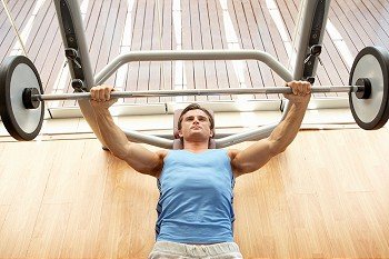 Man Working With Weights In Gym