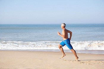 Senior man running on beach