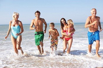 Three generation family play on beach