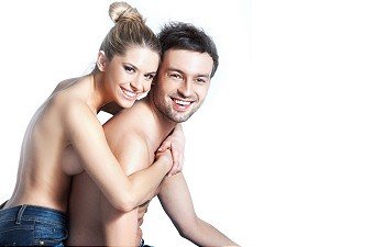 Young couple in blue jeans on white background