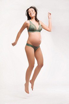 Jumping happy pregnant woman