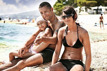 Young family embracing on a sandy beach