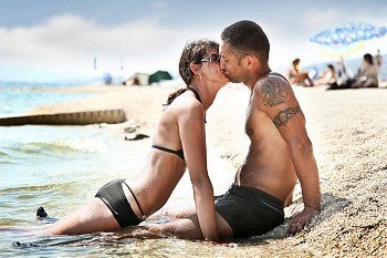 Attractive couple relaxing on the beach