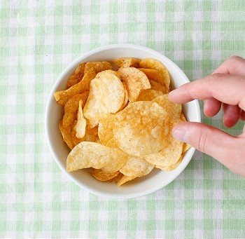Snacking from the potato chips bowl
