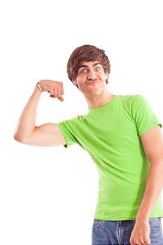 young man makes a funny grimace while showing his biceps